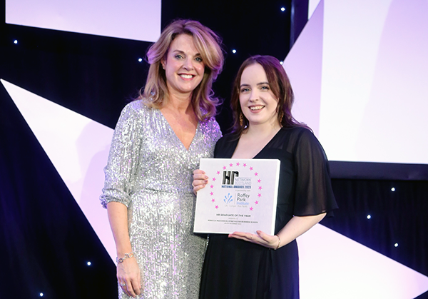 Image shows Rebecca at the ceremony holding her award