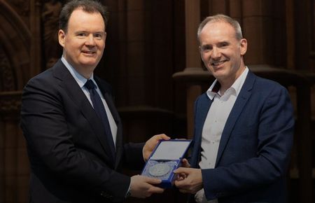 Michael Harker receiving his medal from the pricipal