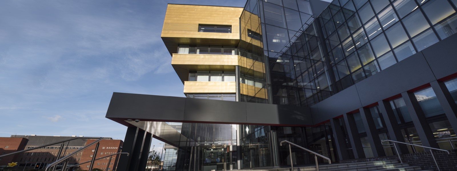 A backdrop showing a side view of the Business School building in Cathedral Street